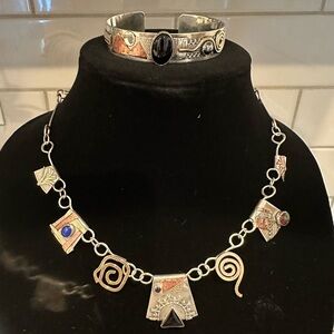Artisan crafted sterling silver necklace with various other metals and stones